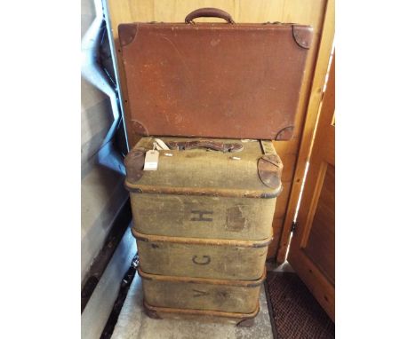 A shipping trunk and a brown suitcase