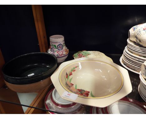 A Royal Doulton hollyhocks decorated bowl, a Carlton ware foxglove leaf dish, a Poole Pottery vase and a Royal Doulton blue a