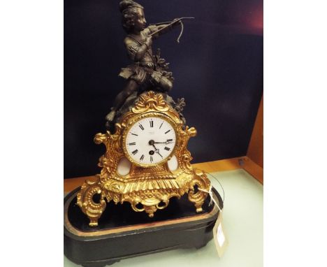 A French gilt spelter figural mantle clock the enamel dial with Roman numerals inscribed 'Rollin Paris' surmounted with an ar
