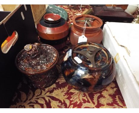 An early lacquered wooden caddy together with three ceramic tobacco jars one in the form of a tree stump