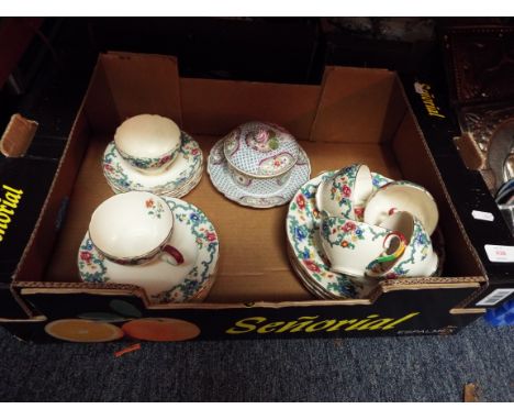 A Royal Cauldon 'Victoria' part tea service together with a Meissen style hand-painted muffin dish with rose bud finial 