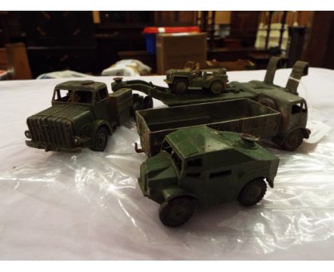 Four Dinky military vehicles comprising of a Tank Transporter No 660, a Ton Army Truck No 622, an Austin Champ, and a field A