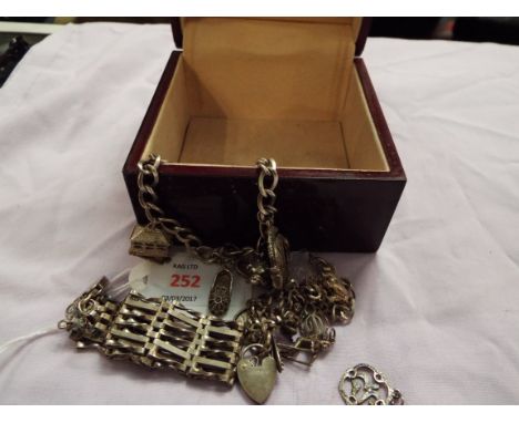 A six bar gate bracelet together with two silver charm bracelets 
