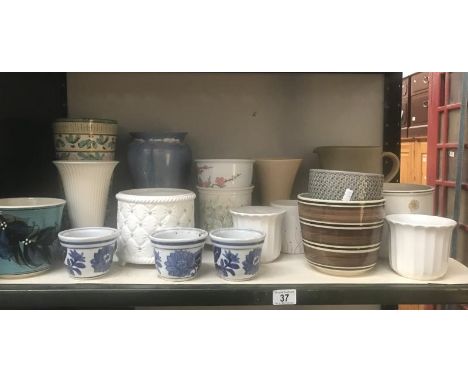 A shelf of ceramic pots &amp; vases