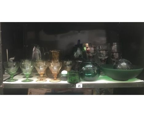 A shelf of drinking glasses, glass bowls &amp; vases