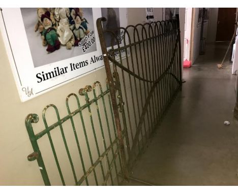 A large wrought iron driveway gate &amp; a smaller wrought iron pathway gate
