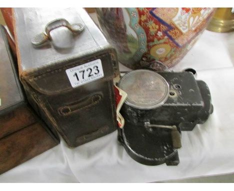 A vintage film item in leather case.
