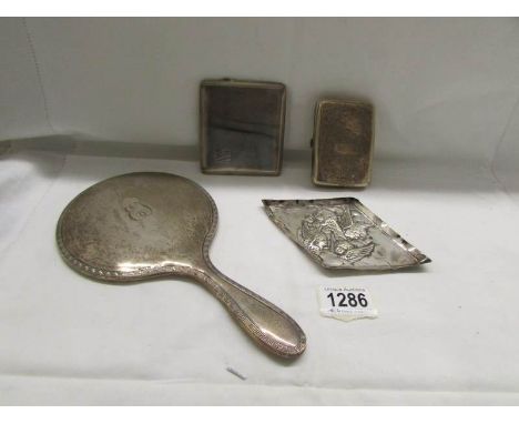 A silver cigarette case, a silver backer hair brush, a silver pin tray and an silver engine turned cigarette case.