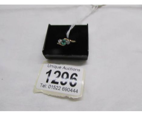 An 18ct yellow gold ring set central emerald and 2 diamonds, size O.
