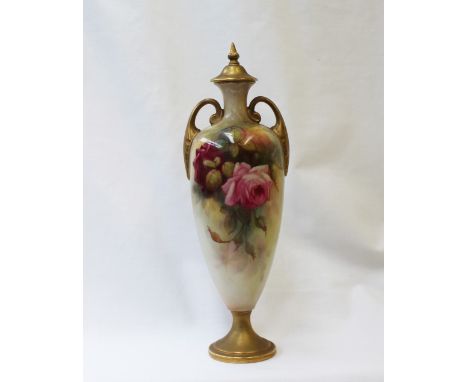 A Royal Worcester porcelain twin handled vase and cover the cover with a gilt flame finial, the body decorated with roses and