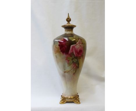 A Royal Worcester porcelain vase and cover, the cover with a pointed finial, the body painted with roses and leaves signed Se