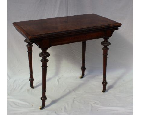 A Victorian burr walnut card table, the rectangular crossbanded top above a shallow frieze on four tapering carved legs and c