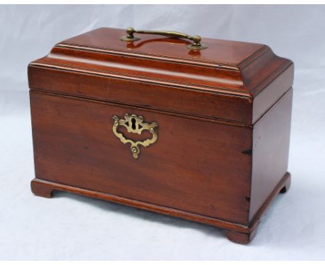 A Victorian mahogany tea caddy of rectangular form with a brass carrying handle