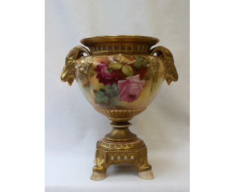 A Royal Worcester porcelain vase with a flared rim and twin rams head handles on a square base with hoof feet, the body paint