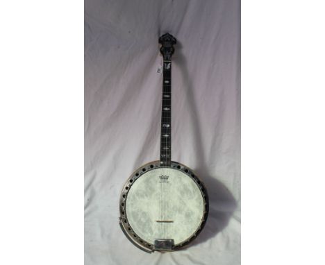 A Paragon four string banjo, with mother of pearl inlay and a veneered back and sides, 86cm long x 33cm diameter CONDITION RE