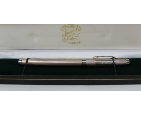 An Elizabeth II silver fountain pen, with an engine turned body with a plain panel initialled HGD