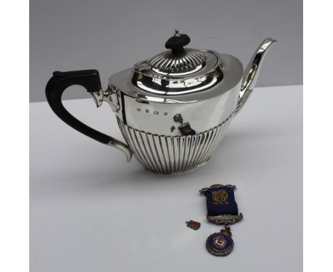 A late Victorian silver teapot of oval form with a half gadrooned body , Birmingham, 1900, approximately 520 grams together w