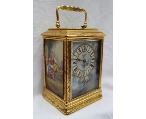 A 19th century gilt brass and repeating carriage clock, the case with leaves and scrolls, set with three porcelain panels dec