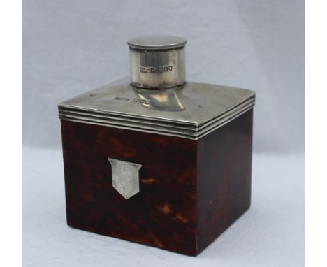 A late Victorian silver and tortoiseshell tea caddy, of rectangular form with a cylindrical cover, with a silver top and shou