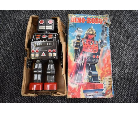 A 1960's SH (Japan) tin plate and battery operated Dino-Robot having open and closed head to reveal a dinosaur head, battery 