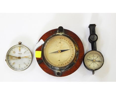 Small brass compass on wooden plaque, a continental metal and glass compass and a German black metal folding compass with fol