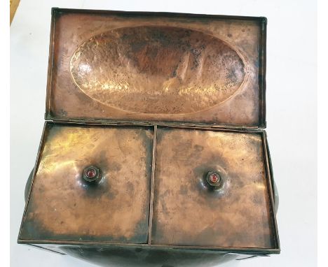 An Arts and Crafts copper hinged rectangular section tea caddy and cover and two liners, with oval domed panels, the liners m