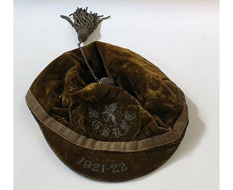 1921 green velvet M.G.S.R.F.C. rugby cap with Lion rampant and having metal thread button and tassel and with embroidered dat