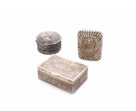 SILVER PILL BOXmarked 925, the hinged cover embossed with Greek key and stylised heart-shaped motifs, 4cm diameter; together 