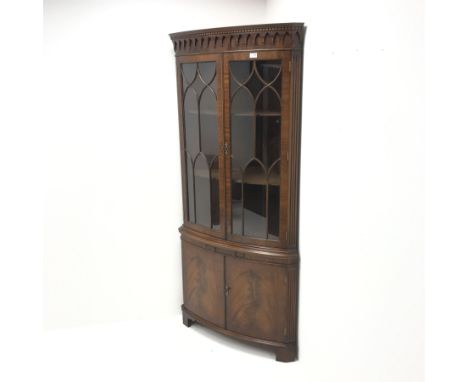 Bevan Funnel Reprodux mahogany double corner cabinet, projecting cornice, dentil frieze, two astragal glazed doors enclosing 