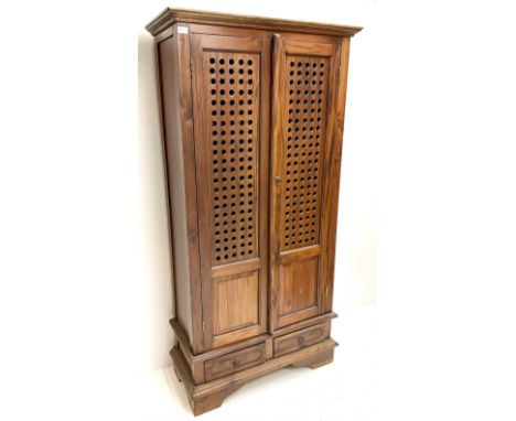 Eastern hardwood bookcase, projecting colonies, two doors enclosing three shelves above two drawers, shaped bracket supportsD