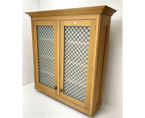 Smallbone light oak bookcase, projecting cornice above two chequered opaque glazed doors enclosing three adjustable shelvesDi