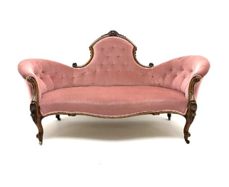 Victorian walnut serpentine framed settee, floral and scroll carving, upholstered in light rose buttoned fabric and detailed 