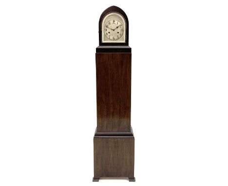 Early 20th century grandmother clock in walnut finish case, lancet shaped top with silvered dial and Arabic chapter ring, twi
