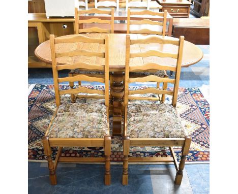 A Mid 20th Century Oak Extending Drop Leaf Oval Topped Dining Table and Set of Four Ladder Back Chairs