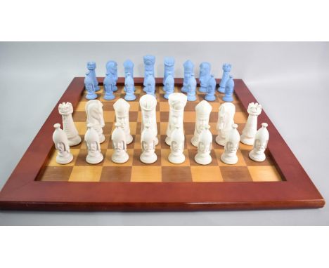 An Interesting Cast Ceramic Chess Set, Kings 11cms High on Wooden Chessboard, 51cms Square