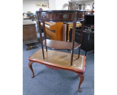 An inlaid two tier serpentine front hall table fitted with a drawer together with a coffee table with an inset leather panel.