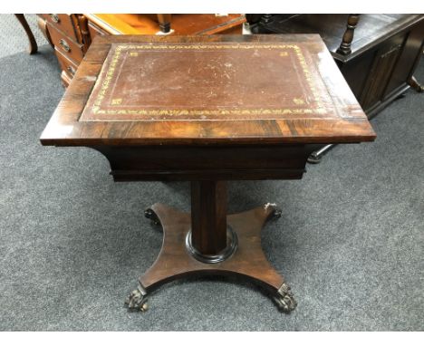 A Regency rosewood pedestal occasional table with a leather inset panel on claw feet.