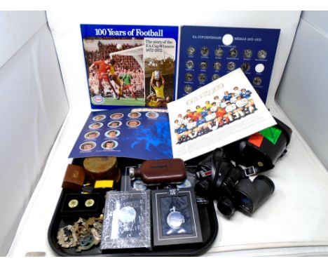 A tray containing FA Cup centenary and Top Team collectors albums, Atlas pocket watches, cap badges, hip flask etc. 