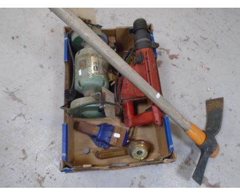 A pickaxe together with a box containing barometer, bench vice, bench top grinder and a Hilti TE-52 110v rotary hammer drill.