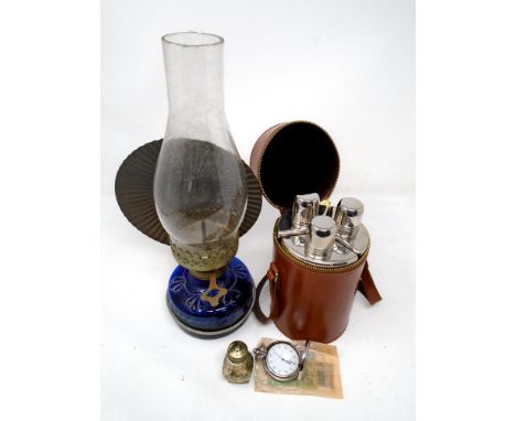 A set of three glass travel flasks in leather carry case together with oil lamp, silver plated sifter, contemporary pocket wa