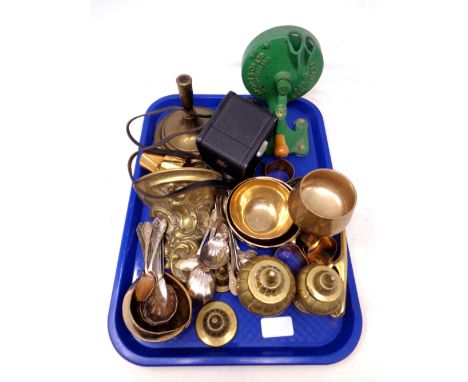 A tray containing metalware including a brass wall bracket, candlestick, napkin rings, plated cutlery, cast iron spong, vinta