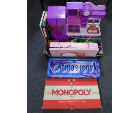 A box containing assorted toys, board games, a Chinese international chess set.