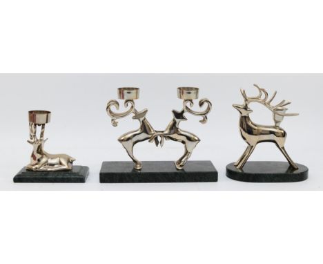 A pair of chrome plated rutting reindeer candlestick, raised on a marble base, 16.5cm and two other similar candlesticks (3)