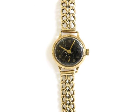 A ladies' 9ct gold Tissot mechanical bracelet watch, 22mm diameter with a black dial, Arabic numerals and subsidiary seconds 