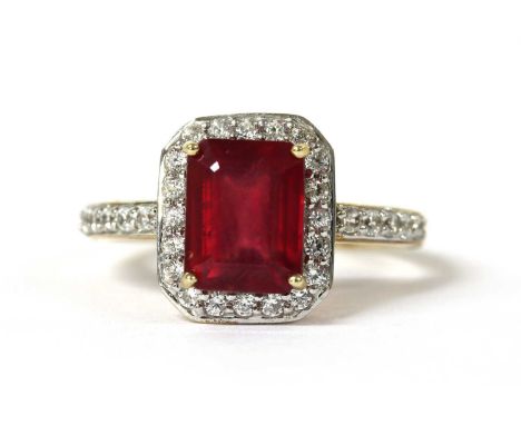 A 9ct gold fracture filled ruby and zircon halo cluster ring, with an emerald cut fracture filled ruby, approximately 9 x 7mm