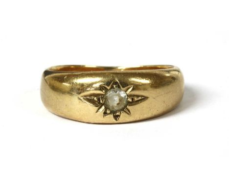 A gentlemen's gold single stone paste ring, with a circular paste star set to the tapered head, with plain shank, tested as a