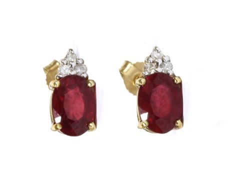 A pair of 9ct gold fracture filled ruby and diamond earrings, with an oval mixed cut fracture filled ruby, approximately 7 x 