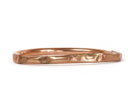A gold hollow bangle, dented and cracked, tested as approximately 9ct gold, 9.74g (a/f) Condition report: Bangle is very dent