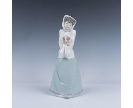 Lovely young figurine dressed for winter holding her dog. Colored in white, pale blue and brown. Nao backstamp. 1296. This it