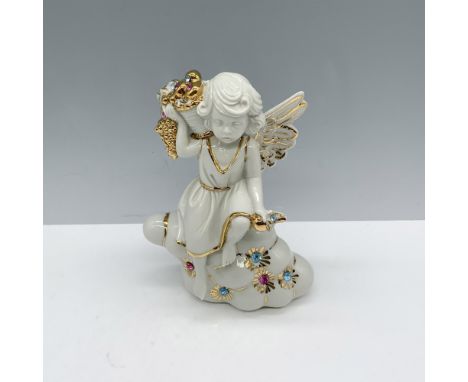 Beautiful white porcelain figure of a winged young girl sitting on a cloud as she holds a basket of fruit and Swarovski cryst